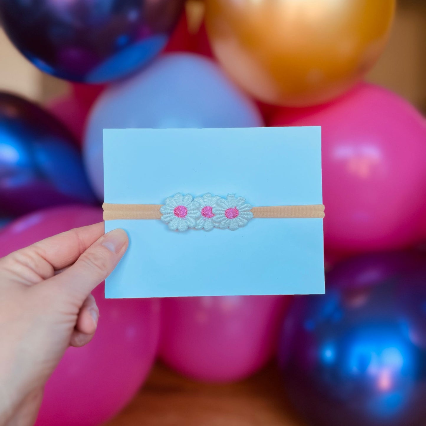 Baby haarbandje - elastiek - met madeliefjes - donkerroze - bloemen - bloemetjes