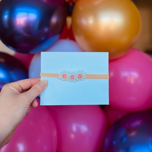 Baby haarbandje - elastiek - met madeliefjes - oranje/roze - bloemen - bloemetjes